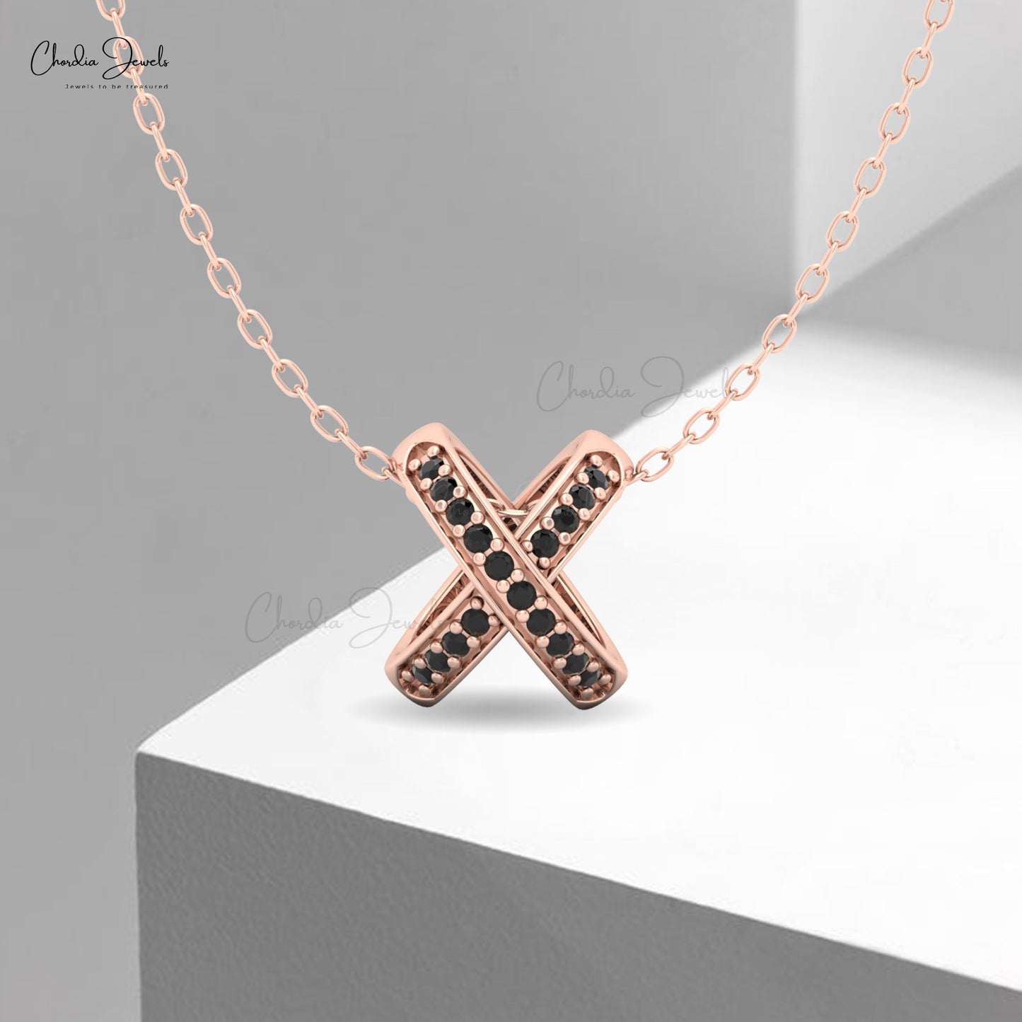 Rose gold X pendant necklace with black diamond accents on a delicate chain – minimalist luxury jewelry by Chordia Jewels.