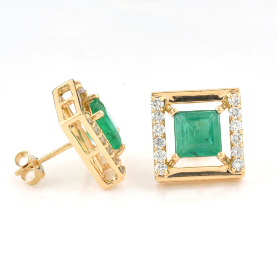 Halo design 14k gold earrings featuring natural emeralds