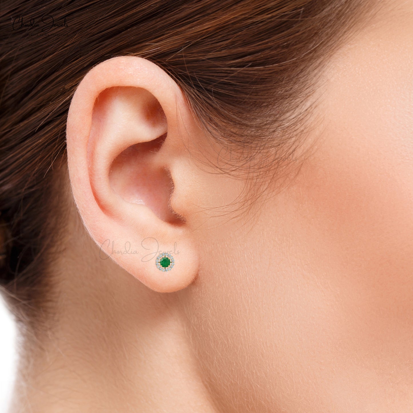 Embrace the allure of emerald and diamond halo studs.