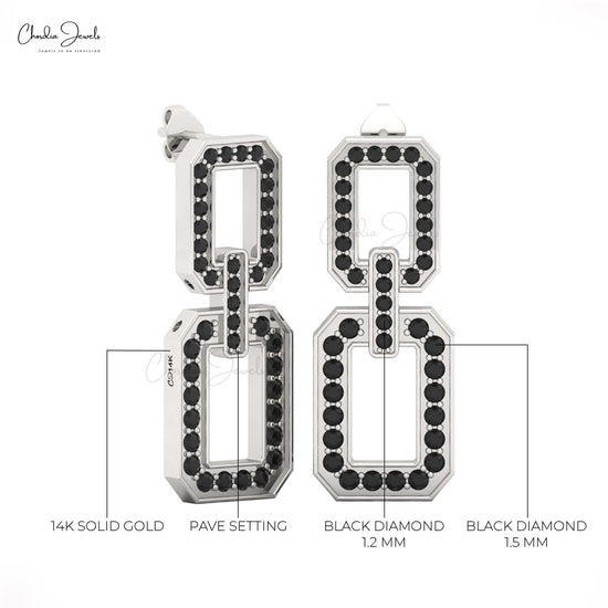 Detailed shot of handcrafted 14K gold earrings with black diamonds