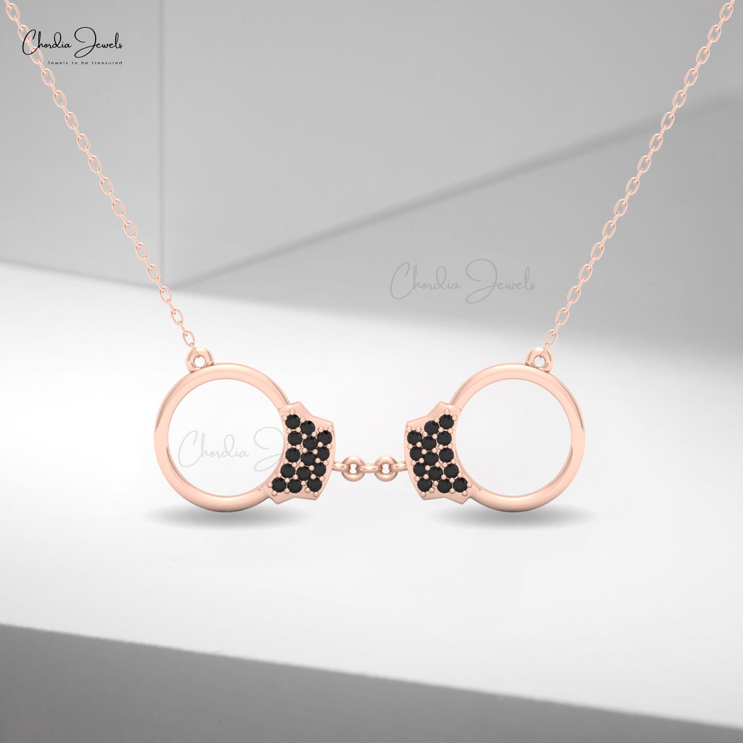 Elegant women’s gold necklace with black diamond handcuff charm