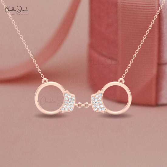 Luxury 14k gold necklace featuring handcuff pendant with white diamonds