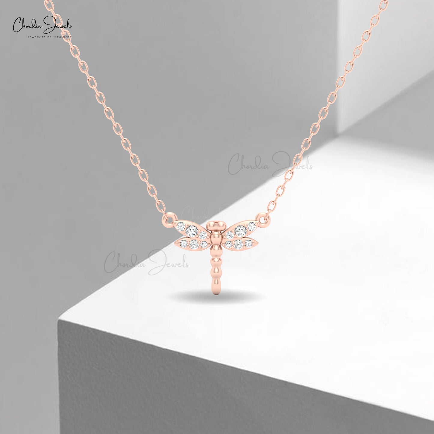 Elegant dragonfly pendant in rose gold with crystal detailing by Chordia Jewels.