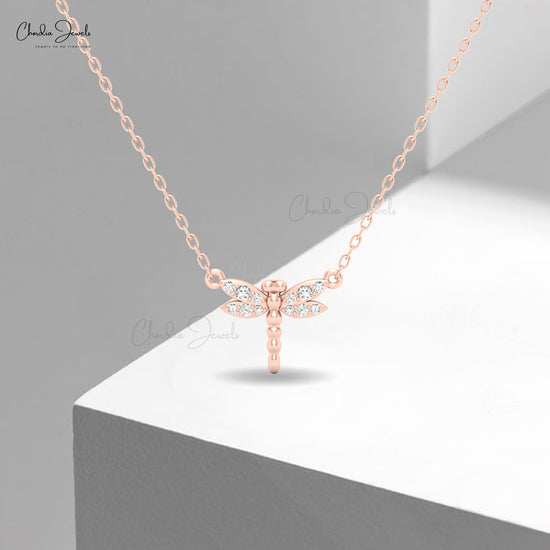 Elegant dragonfly pendant in rose gold with crystal detailing by Chordia Jewels.