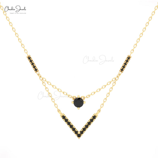 Chveraon 14k gold necklace with V-shaped black diamond pendant.