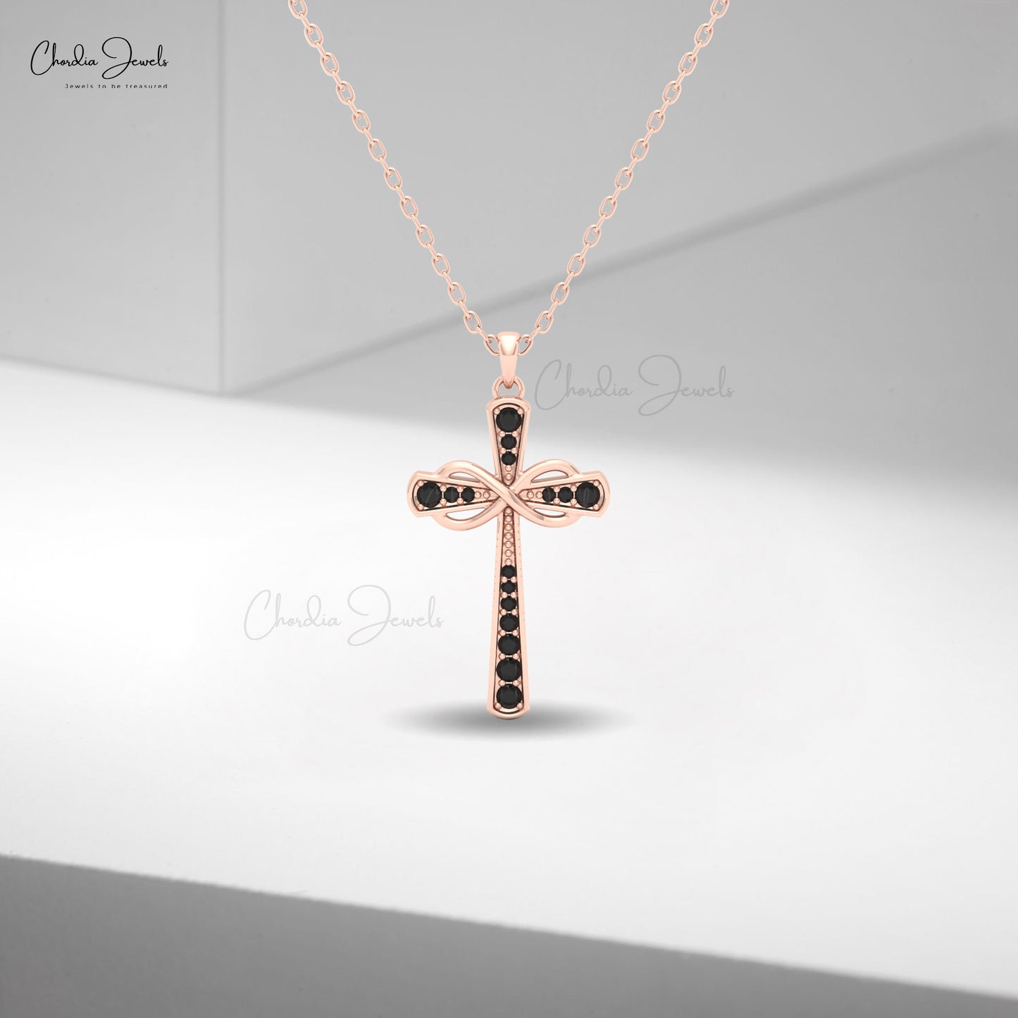 Women’s 14k rose gold infinity pendant adorned with round black diamonds in pavé setting.