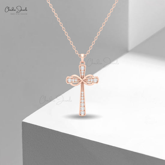 Elegant women's cross necklace in 14k solid gold featuring white diamonds and fine craftsmanship.