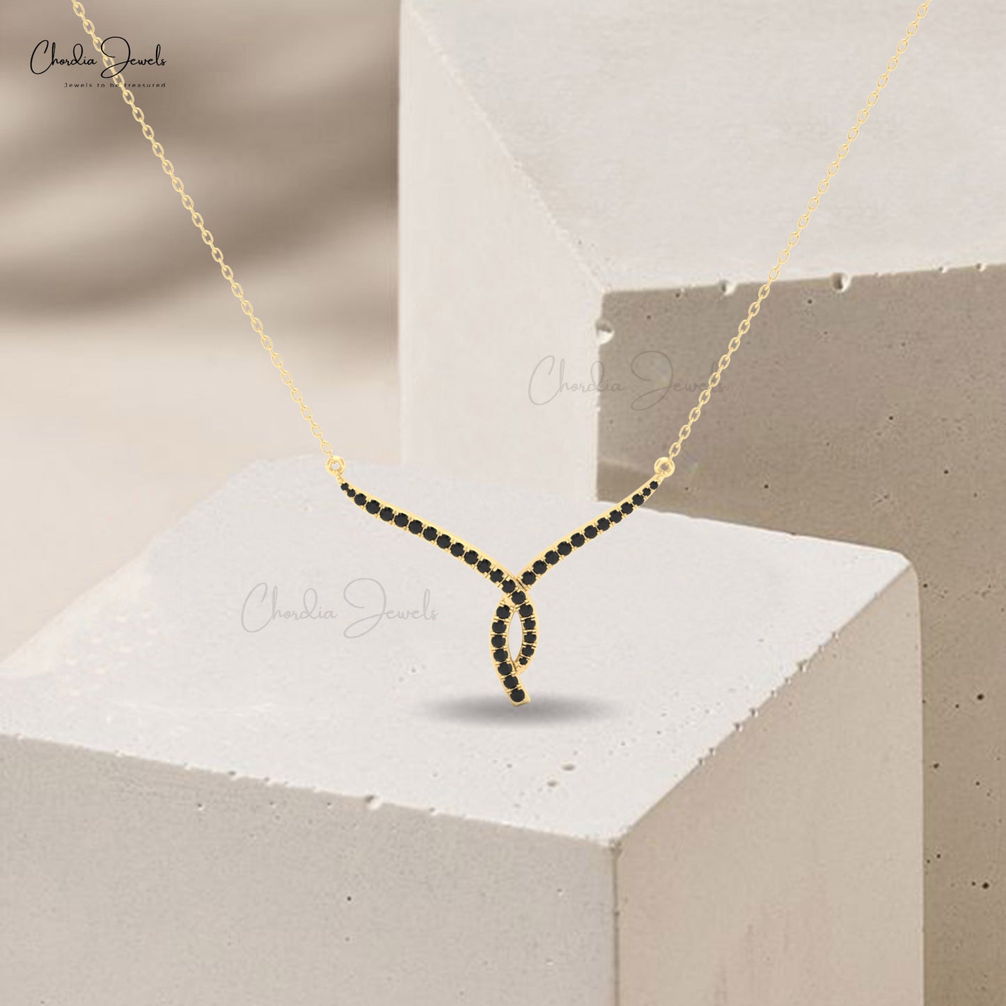 Women’s 14K solid gold twisted necklace adorned with black diamonds.
