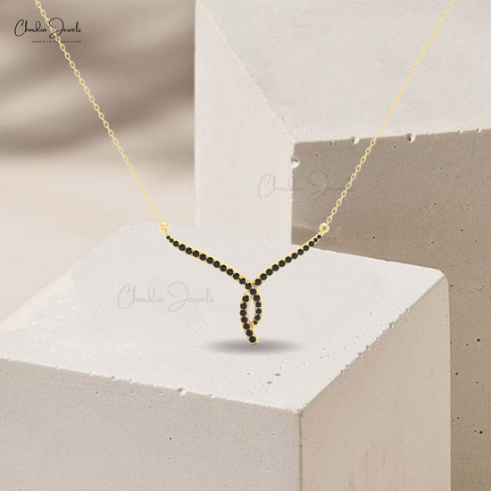 Women’s 14K solid gold twisted necklace adorned with black diamonds.