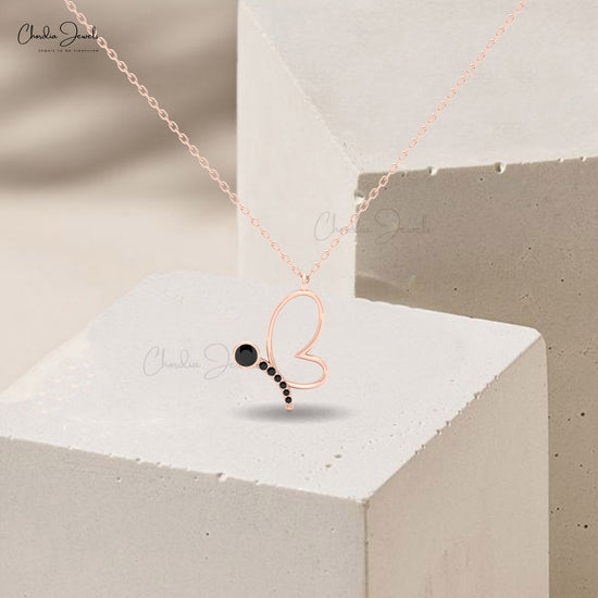Women’s necklace featuring butterfly charm and black diamond.